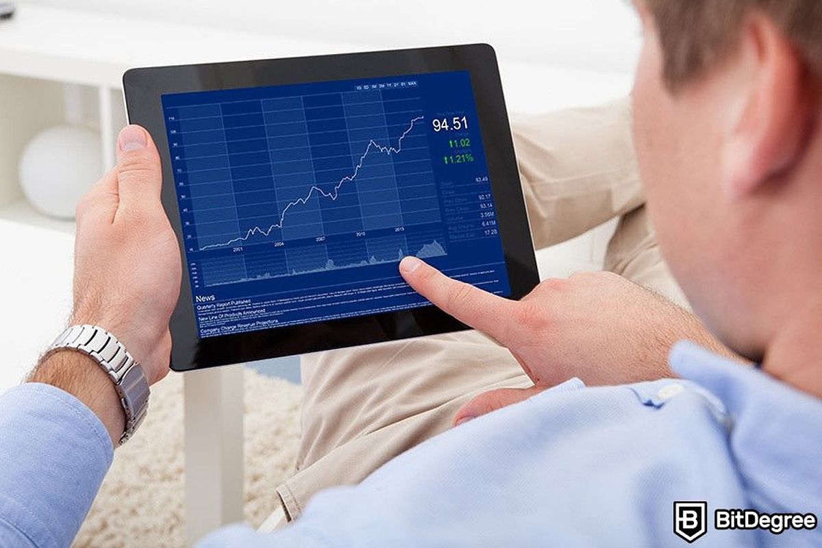 Best cryptocurrency broker: a man pointing at a tablet with some charts