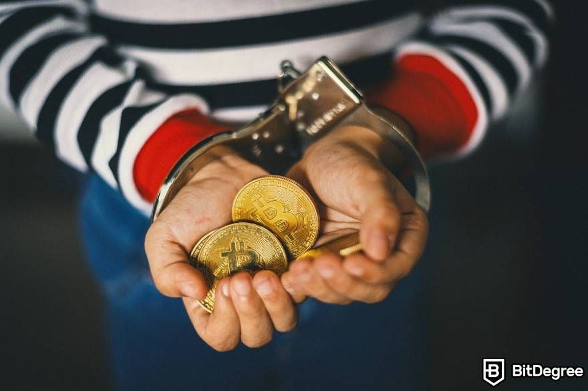 Handcuffed man holding a pile of physical BTC coins